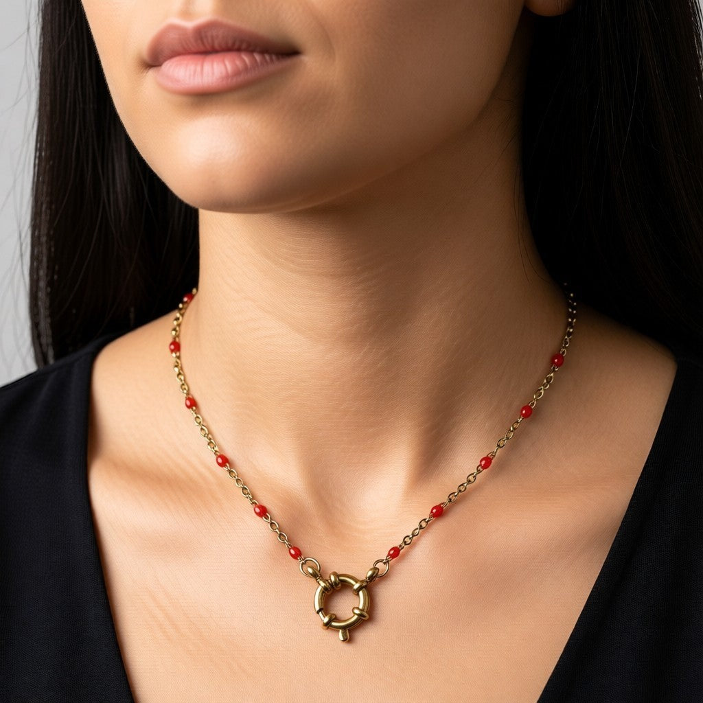 Aramat Jewels gold chain necklace with small red enamel beads and a large circular clasp.