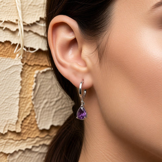 Aramat Jewels silver-tone stainless steel huggie hoop earrings with a dangling purple teardrop zirconia stone