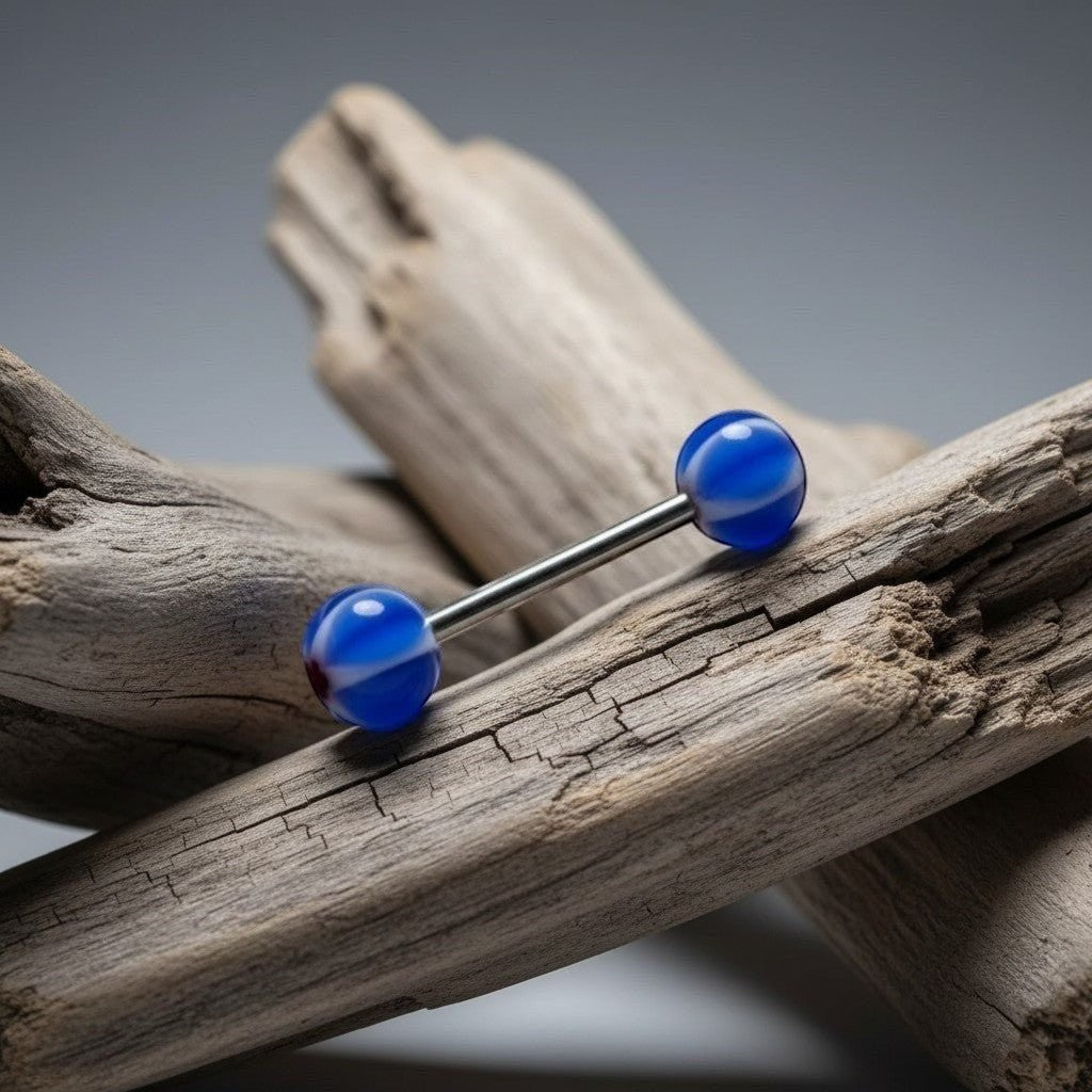 Aramat Jewels blue and white striped acrylic tongue piercing with a red star design on the ball.
