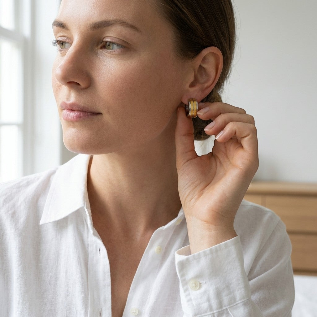 Aramat Jewels bicolor stainless steel huggie earrings with double gold stripes, 13mm diameter.