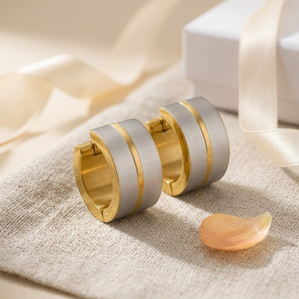 Aramat Jewels matte bicolor stainless steel hoop earrings, 13x7mm, with gold-tone inner and outer bands.