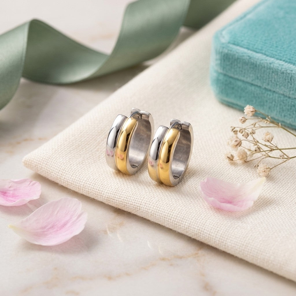 Aramat Jewels bicolor stainless steel hoop earrings, a mix of gold and silver tones, with a glossy finish.