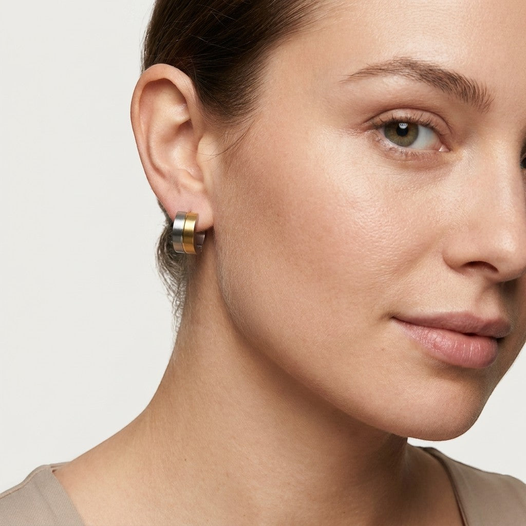 Aramat Jewels bicolor stainless steel hoop earrings with gold and silver stripes, 13mm diameter.