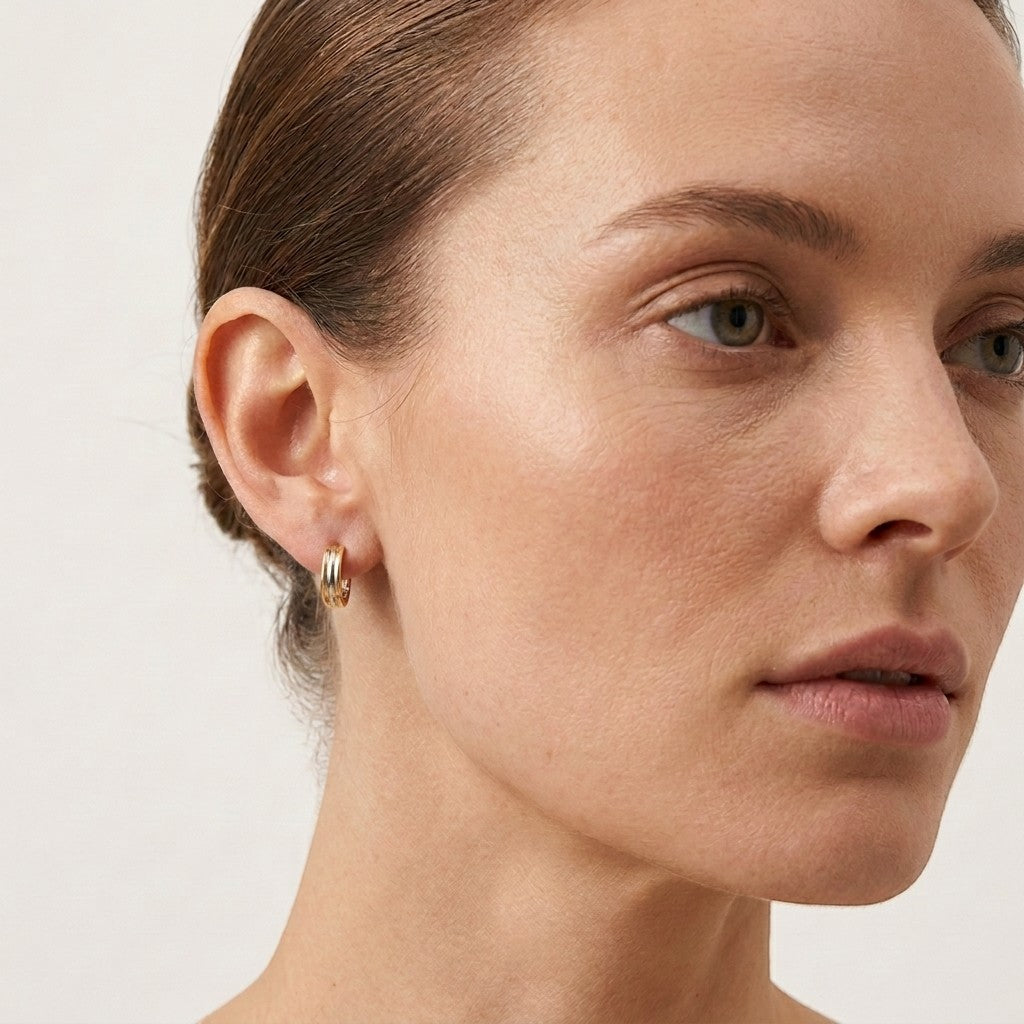 Aramat Jewels bicolor hoop earrings with gold and silver stripes, 13mm diameter, made of stainless steel.