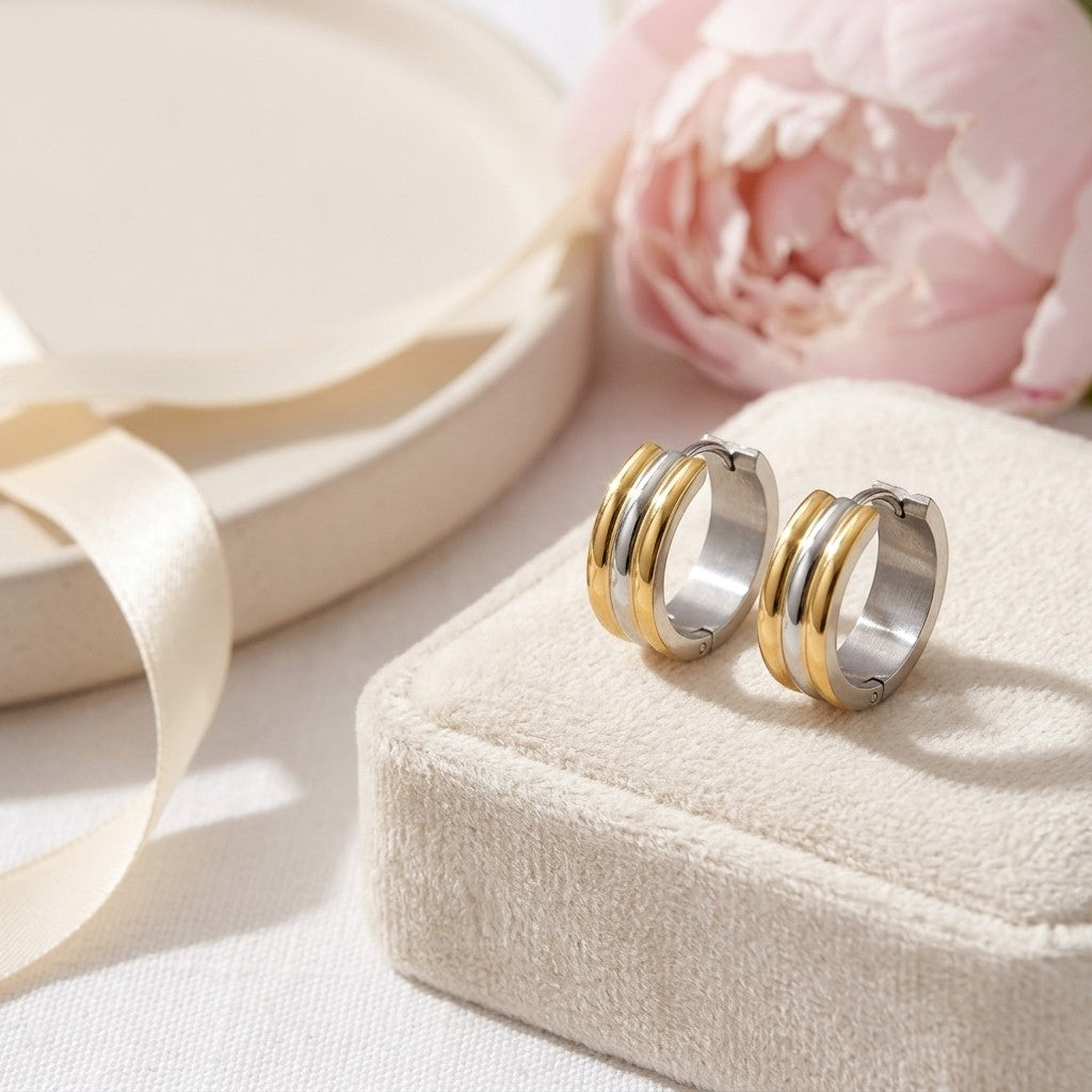 Aramat Jewels bicolor stainless steel hoop earrings with gold and silver stripes, 13mm diameter.