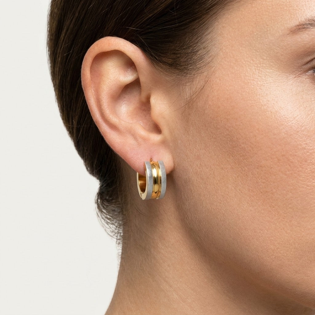 Aramat Jewels bicolor hoop earrings in matte silver and gold stainless steel, 13mm diameter.