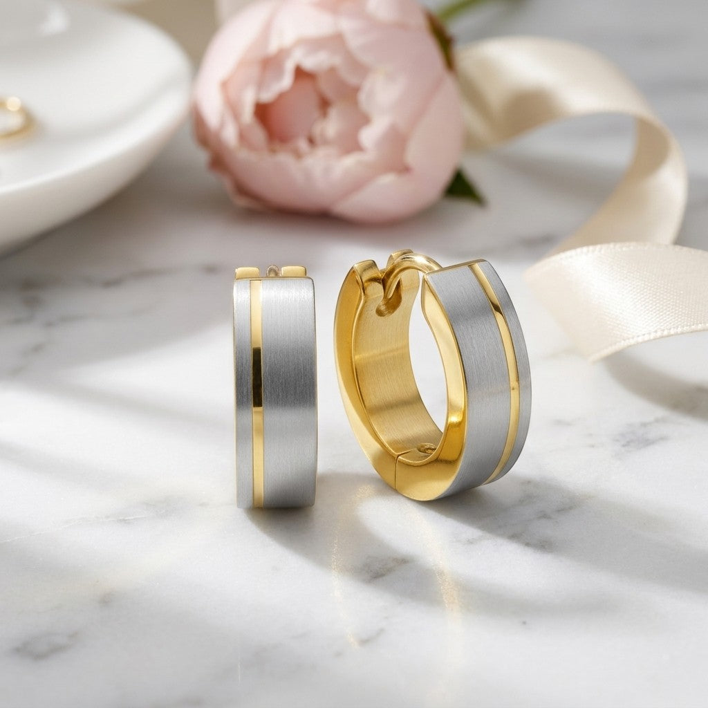 Aramat Jewels bicolor stainless steel hoop earrings with a matte silver finish and a gold stripe detail, 13mm.