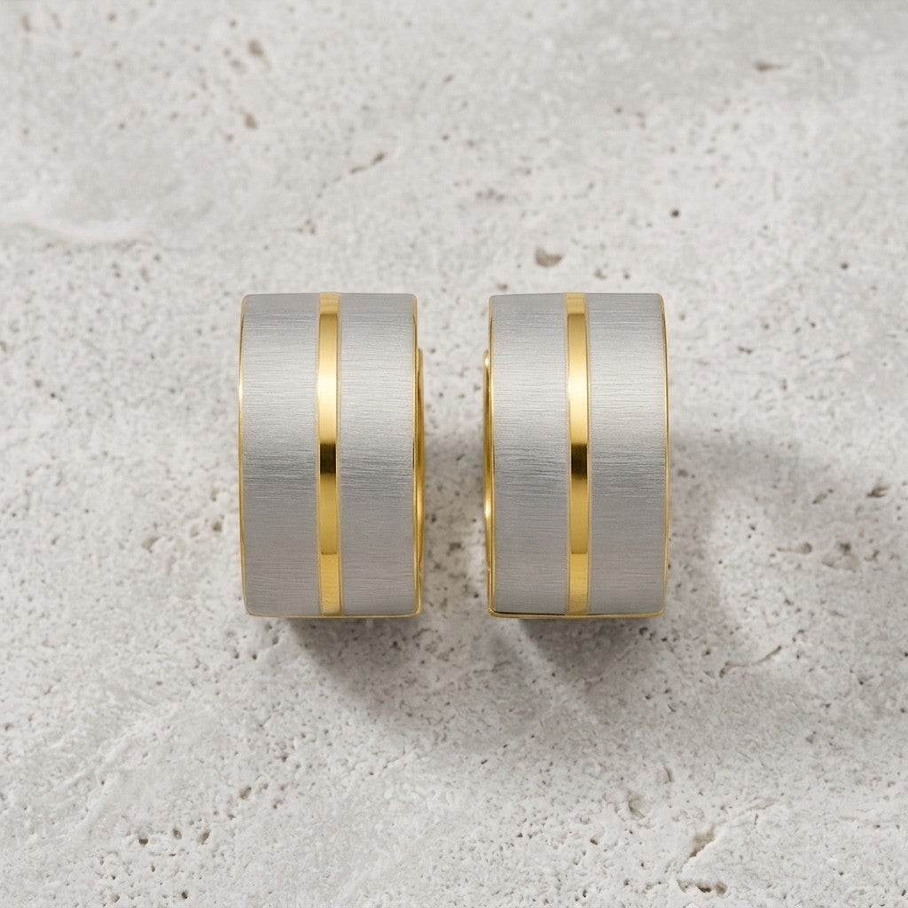 Aramat Jewels matte bicolor stainless steel hoop earrings, 13x7mm, with gold-colored stripes on a silver-colored background.