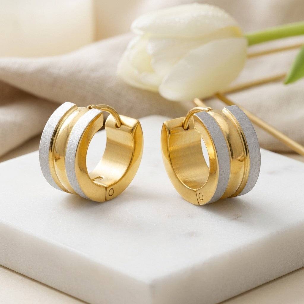 Aramat Jewels bicolor stainless steel huggie hoop earrings, matte silver with gold accents, 13mm diameter.