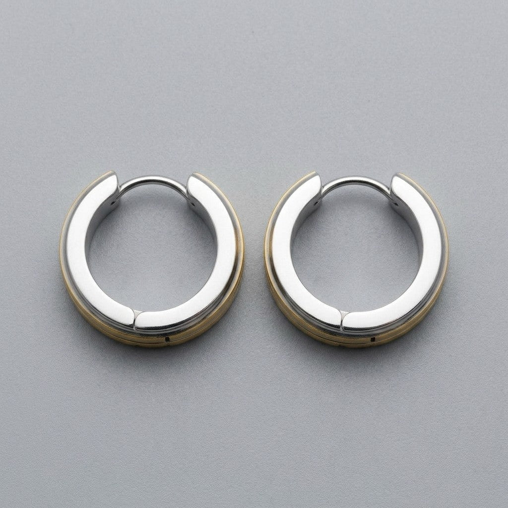 Aramat Jewels stainless steel huggie hoop earrings with a bicolor design featuring silver and gold stripes.