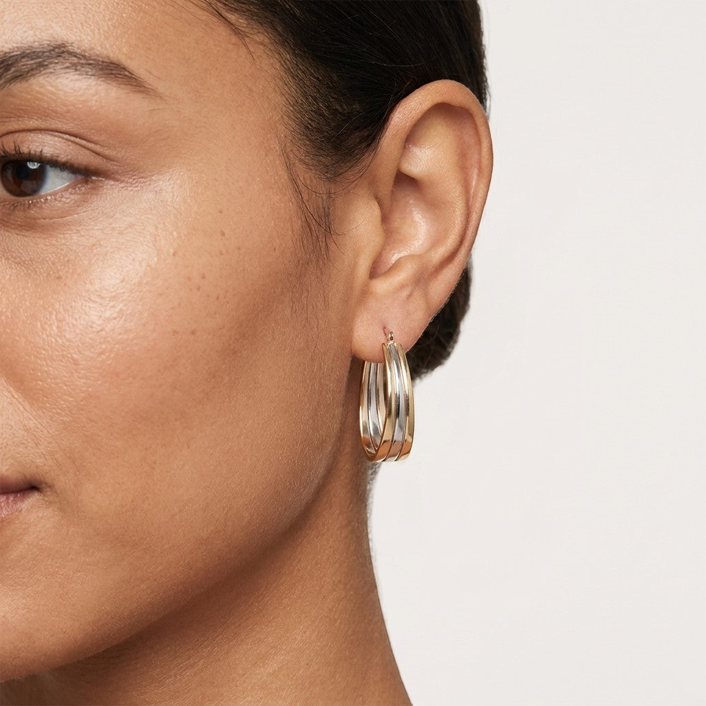 Aramat Jewels triple oval hoop earrings in gold and silver bicolor stainless steel, 35x9mm, with a hinge closure.
