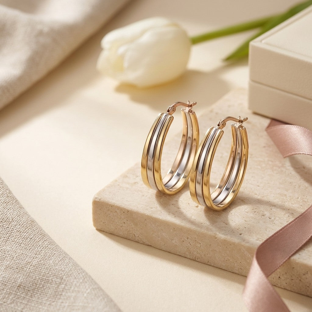 Aramat Jewels triple oval hoop earrings in gold and silver stainless steel, 35x9mm, with a bicolor finish and hinge closure.