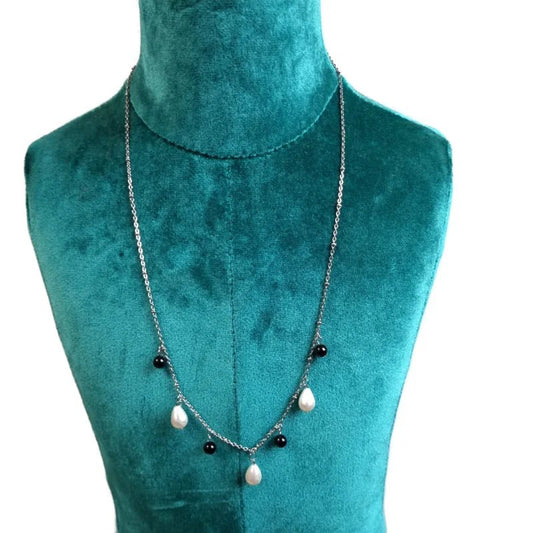 Aramat Jewels silver-tone stainless steel necklace with white teardrop and black round synthetic pearls on a bust