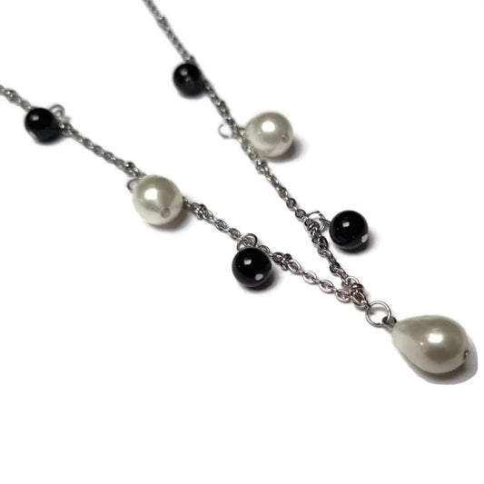 Aramat Jewels silver-tone stainless steel necklace featuring white teardrop pearls and black round synthetic pearls.
