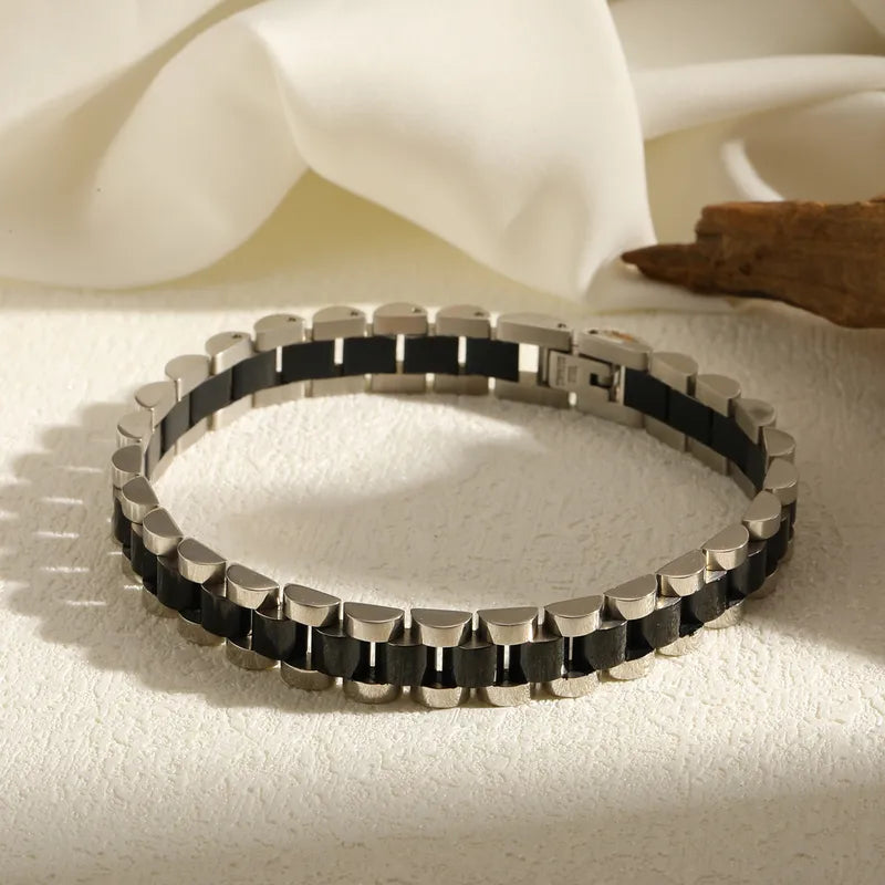 Aramat Jewels bicolor RVS schakelarmband in zwart en zilverkleurig met een horlogeband design van 10mm breed.