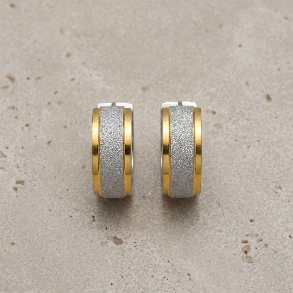 Aramat Jewels bicolor sandblasted stainless steel hoop earrings with a gold stripe detail.