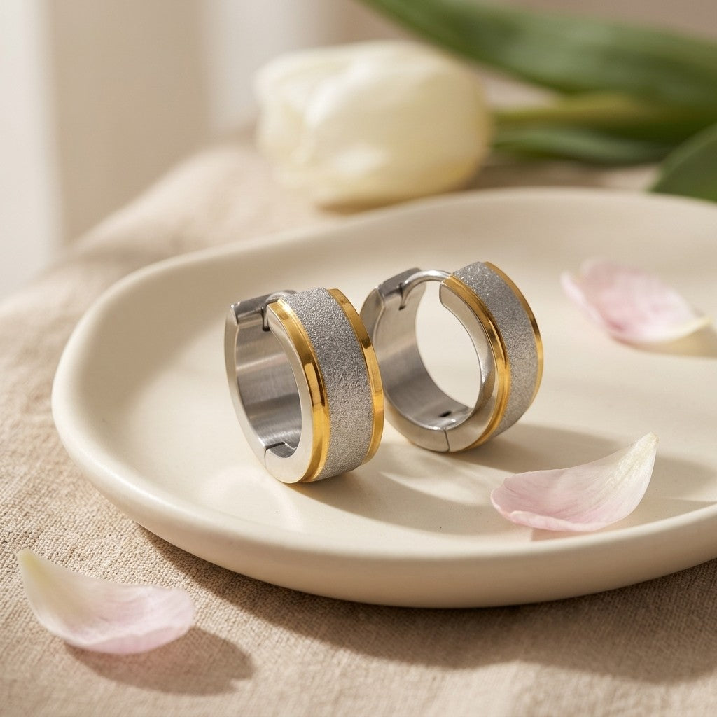 Aramat Jewels bicolor sandblasted stainless steel hoop earrings with a gold-tone accent.