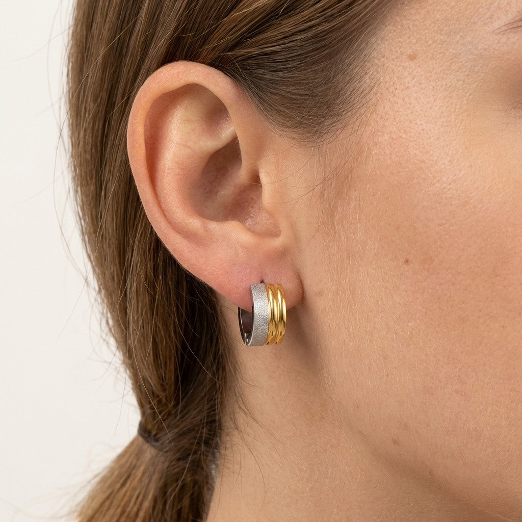 Aramat Jewels bicolor striped huggie hoop earrings in stainless steel, 13mm diameter, featuring alternating matte silver and shiny gold bands.