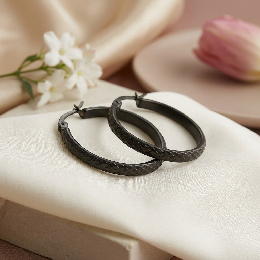Aramat Jewels black stainless steel hoop earrings with a 30mm diameter and a subtle diamond pattern.
