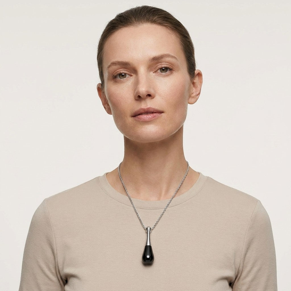 Aramat Jewels black and silver cone-shaped cremation urn pendant necklace for ashes, 4cm, 316L steel.
