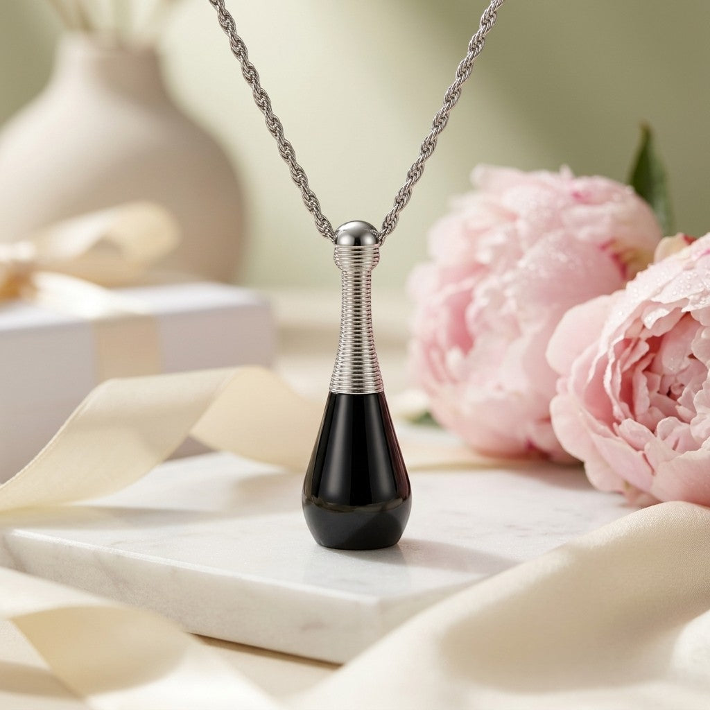 Aramat Jewels black and silver cone-shaped cremation urn pendant necklace made of 316L stainless steel, 4cm long.
