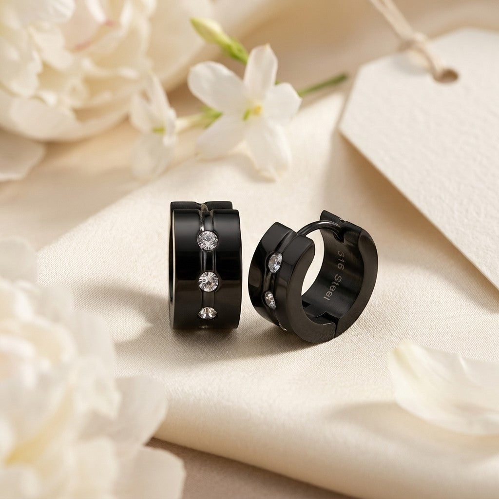 Aramat Jewels black stainless steel huggie hoop earrings with clear cubic zirconia stones, 13mm diameter.