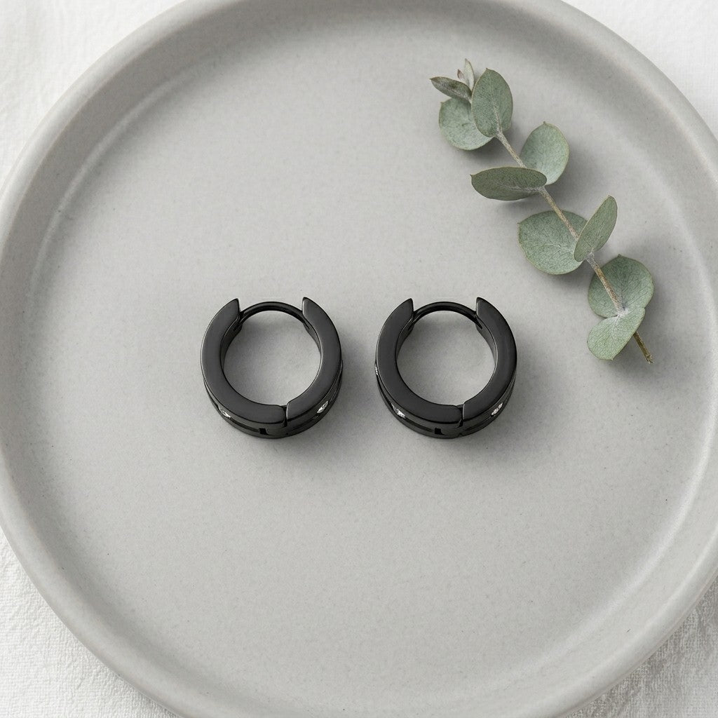 Aramat Jewels black stainless steel huggie hoop earrings with clear cubic zirconia accents, 13mm diameter.