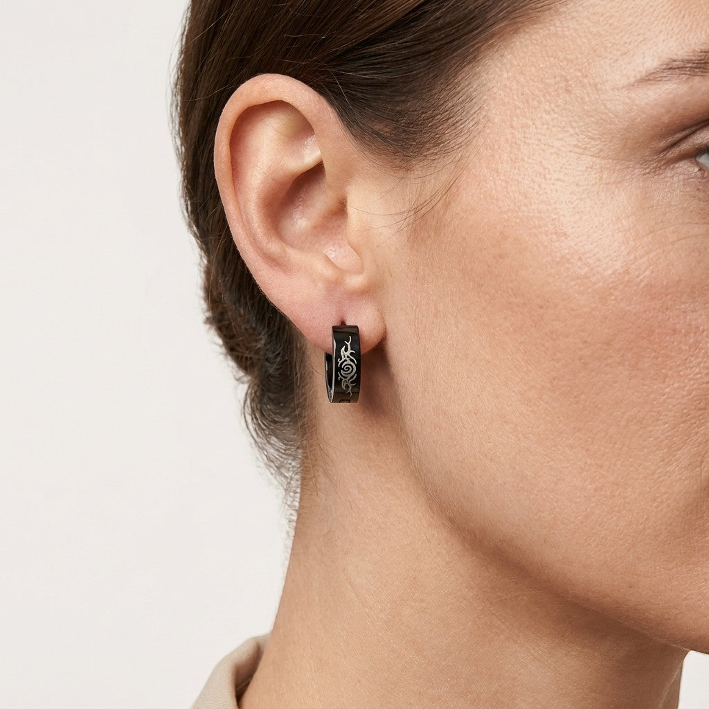 Aramat Jewels black stainless steel tribal huggie earrings, 14mm diameter, with intricate tribal pattern.