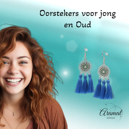 Aramat Jewels blue boho tassel earrings with stainless steel dreamcatcher design worn by a smiling woman