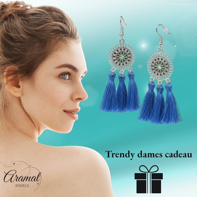 Aramat Jewels blue boho dangle earrings with three tassels and stainless steel mandala design on a woman