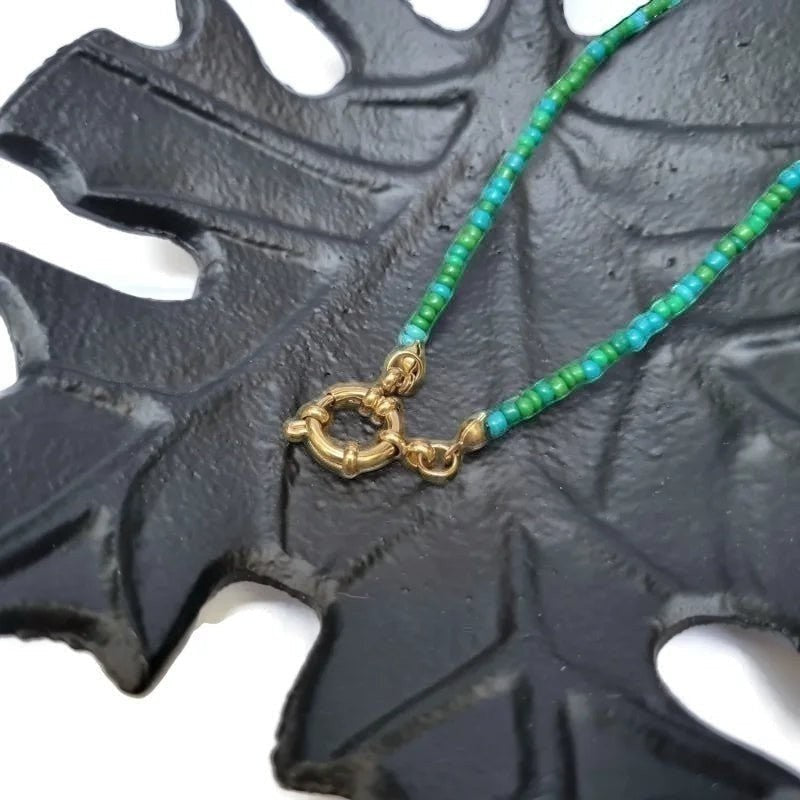 Aramat Jewels beaded necklace with blue and green rocaille beads and a gold-tone clasp.