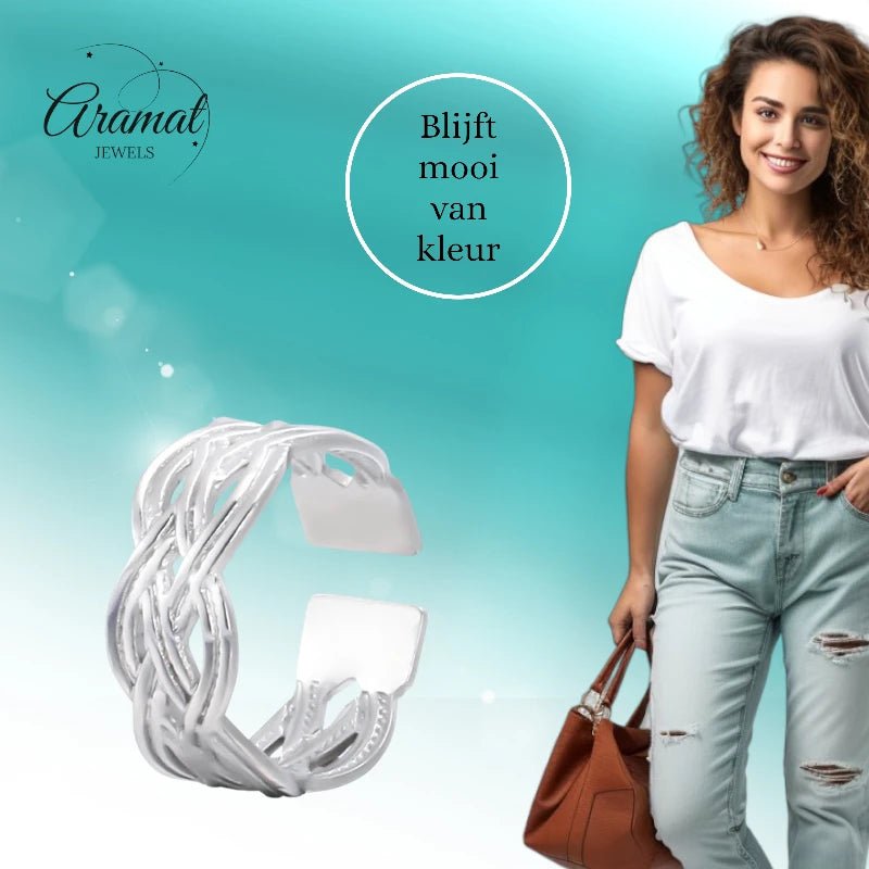 Aramat Jewels adjustable silver stainless steel ring with an intricate Celtic braided design worn by a smiling woman.