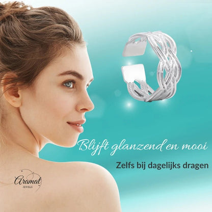 Aramat Jewels adjustable silver-colored stainless steel ring with a Celtic braided knot design worn by a woman