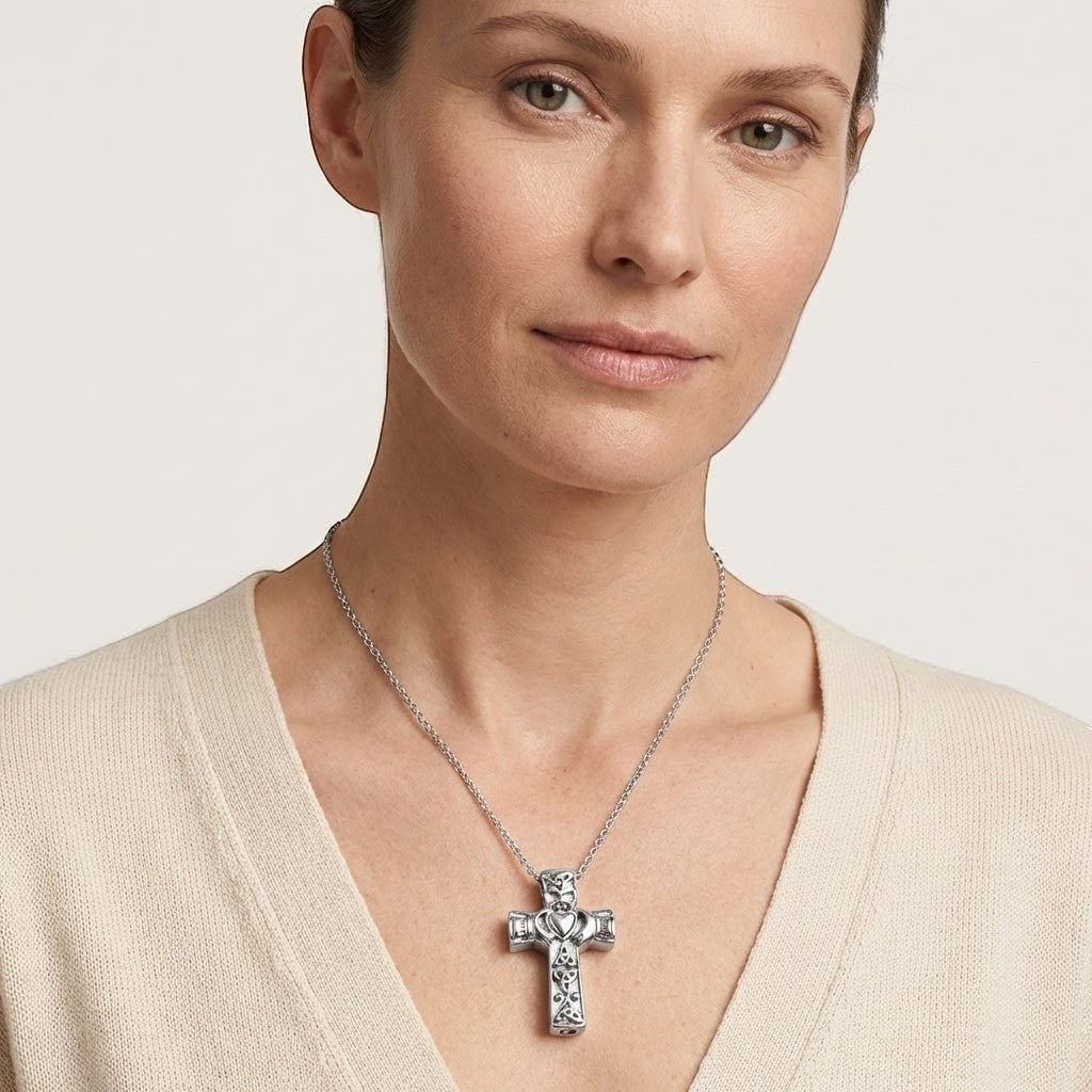 Aramat Jewels silver-tone Celtic cross cremation pendant with black enamel detailing on a woman wearing a cream sweater.