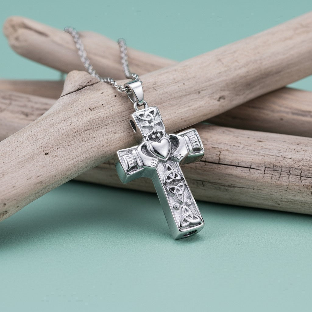 Aramat Jewels silver-tone Celtic cross cremation pendant with intricate knotwork and a heart detail. The pendant is on a silver chain.
