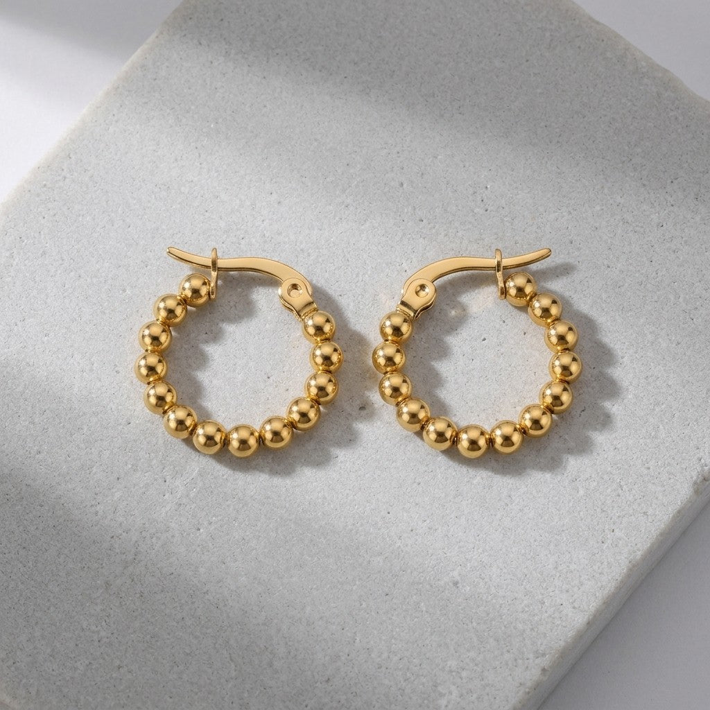 Aramat Jewels gold-tone stainless steel hoop earrings with a beaded chain design, 18mm diameter.