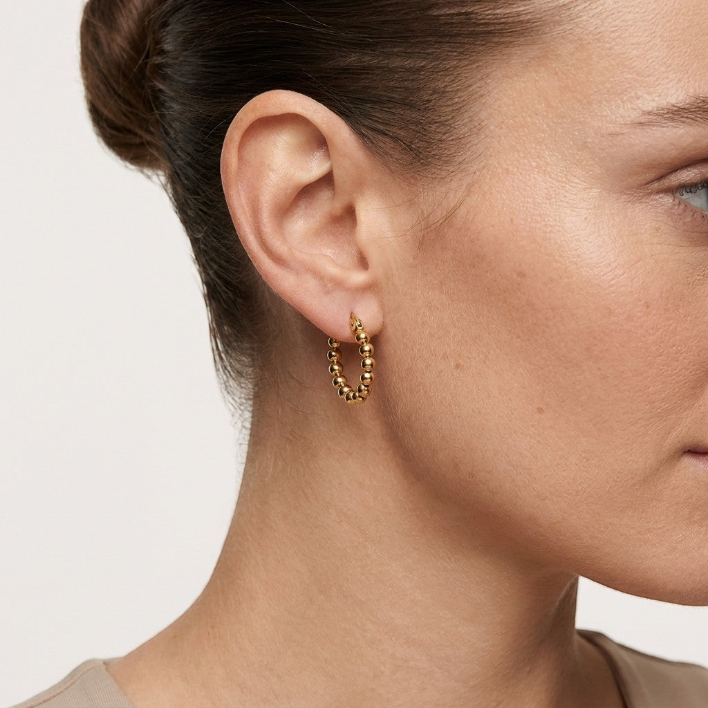 Aramat Jewels gold-tone stainless steel hoop earrings with a beaded chain design, 18mm diameter.