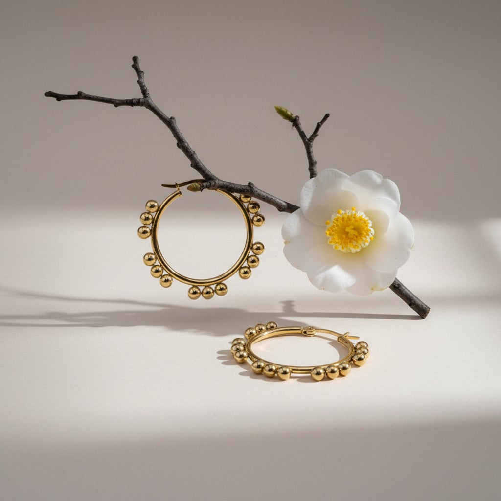 Aramat Jewels gold-tone stainless steel hoop earrings with a beaded design, 35mm diameter.