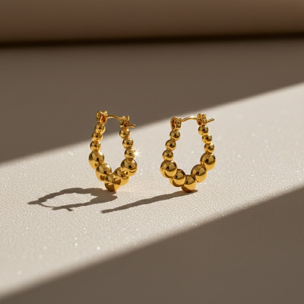 Aramat Jewels gold-tone stainless steel rectangular hoop earrings with a playful beaded pattern, 21x24mm.