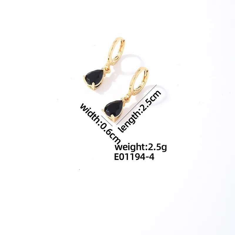Aramat Jewels gold-tone stainless steel huggie hoop earrings featuring a dangling black teardrop zirconia stone.
