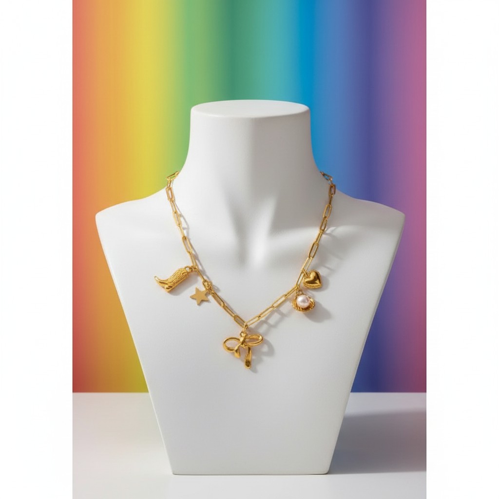Aramat Jewels gold-tone stainless steel necklace with playful charms: bow, cowboy boot, star, shell with pearl, and heart. 45+5 cm adjustable.