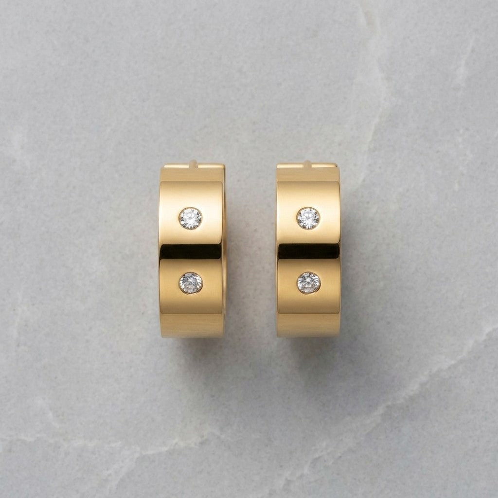 Aramat Jewels gold-tone stainless steel hoop earrings with two clear cubic zirconia stones on each earring.