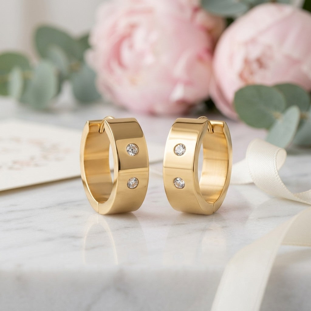 Aramat Jewels gold-tone stainless steel hoop earrings with two clear cubic zirconia stones on each hoop, 13mm or 20mm diameter.