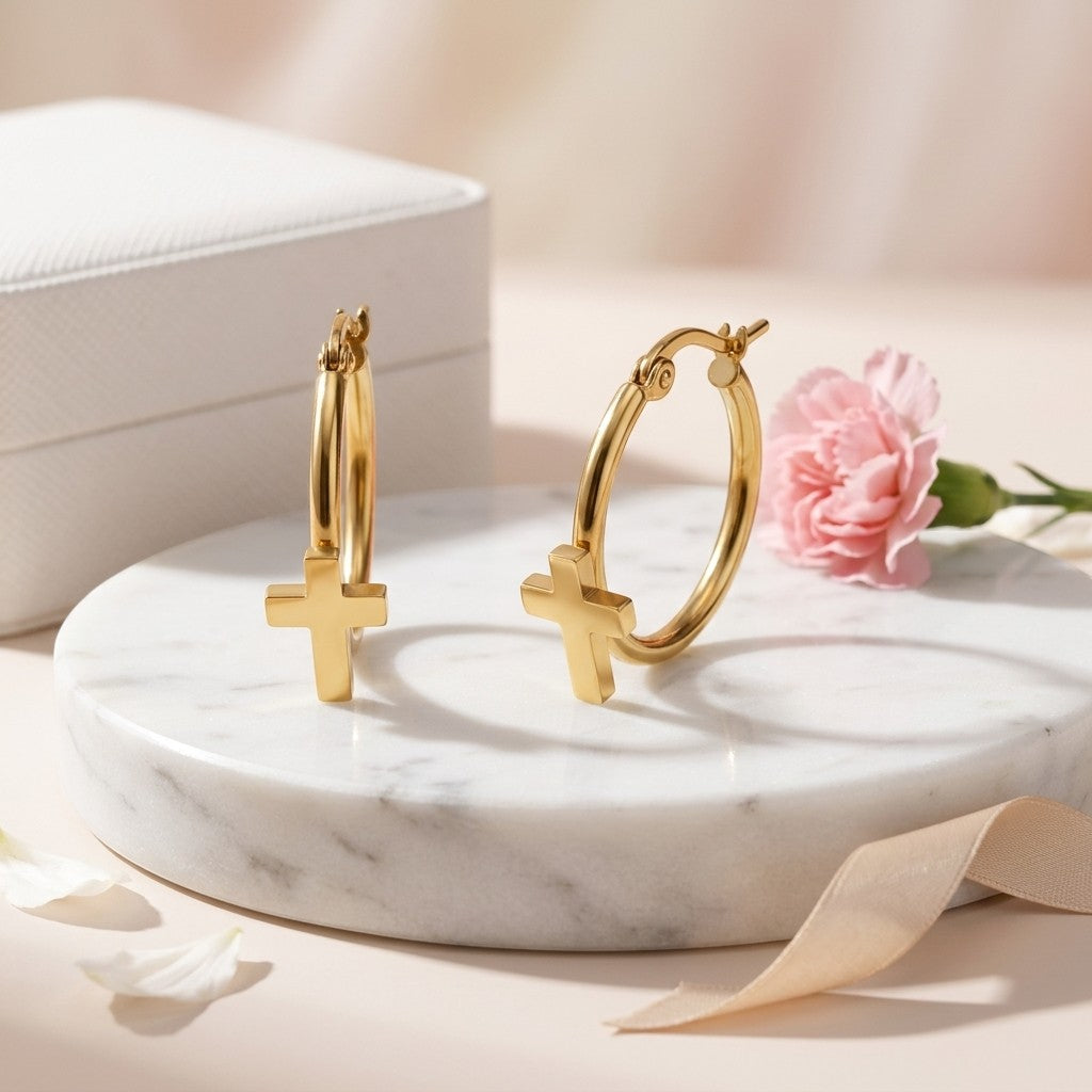 Aramat Jewels gold-tone stainless steel hoop earrings with a cross charm, 25mm diameter.