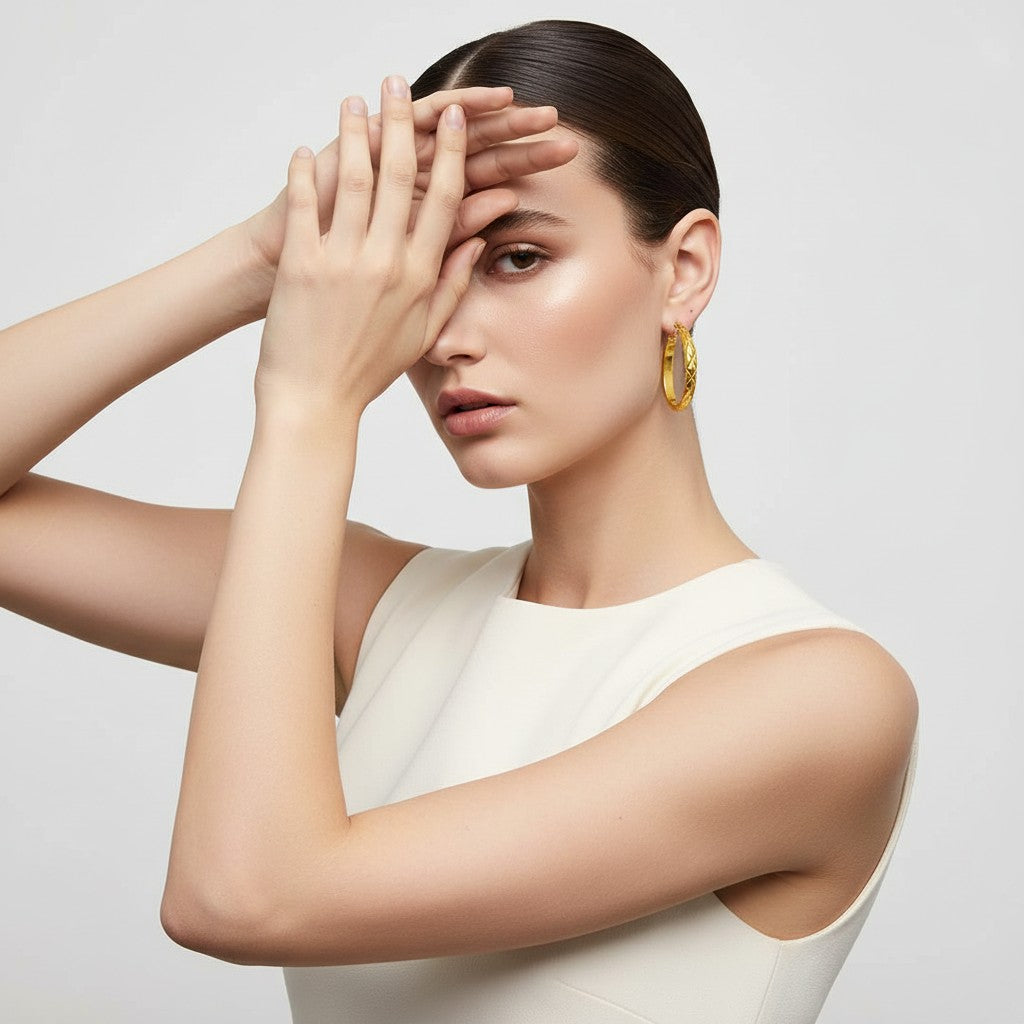 Aramat Jewels gold-tone stainless steel hoop earrings with a diamond pattern, 30mm diameter.