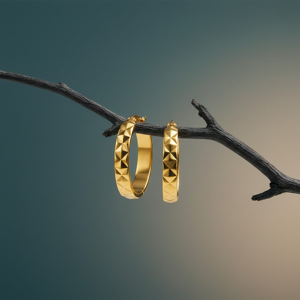 Aramat Jewels gold-tone stainless steel hoop earrings with a diamond-shaped pattern, 25mm diameter.