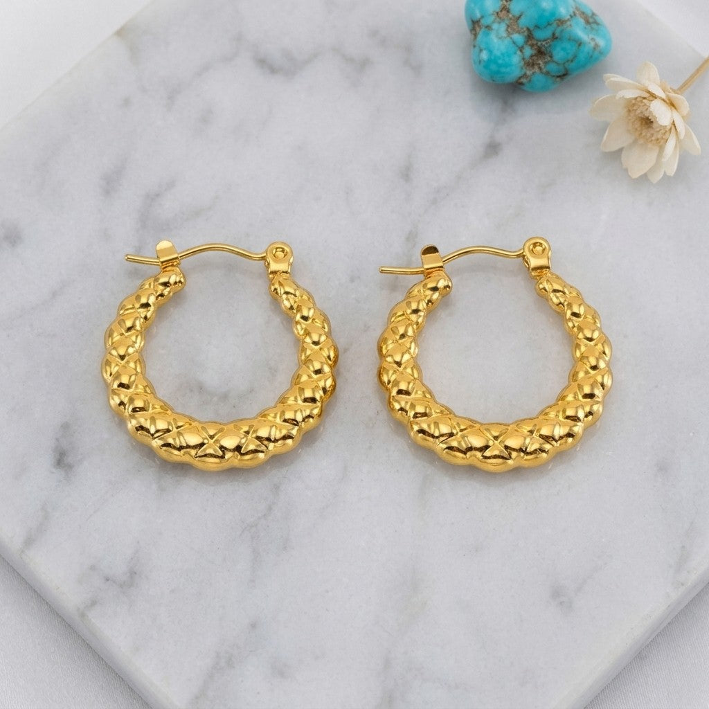 Aramat Jewels gold-tone stainless steel hoop earrings with a textured diamond pattern, 22mm diameter.