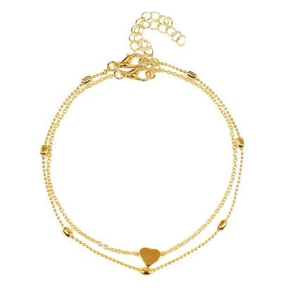 Aramat Jewels gold-colored double-layered stainless steel anklet featuring a small heart charm and delicate beads.