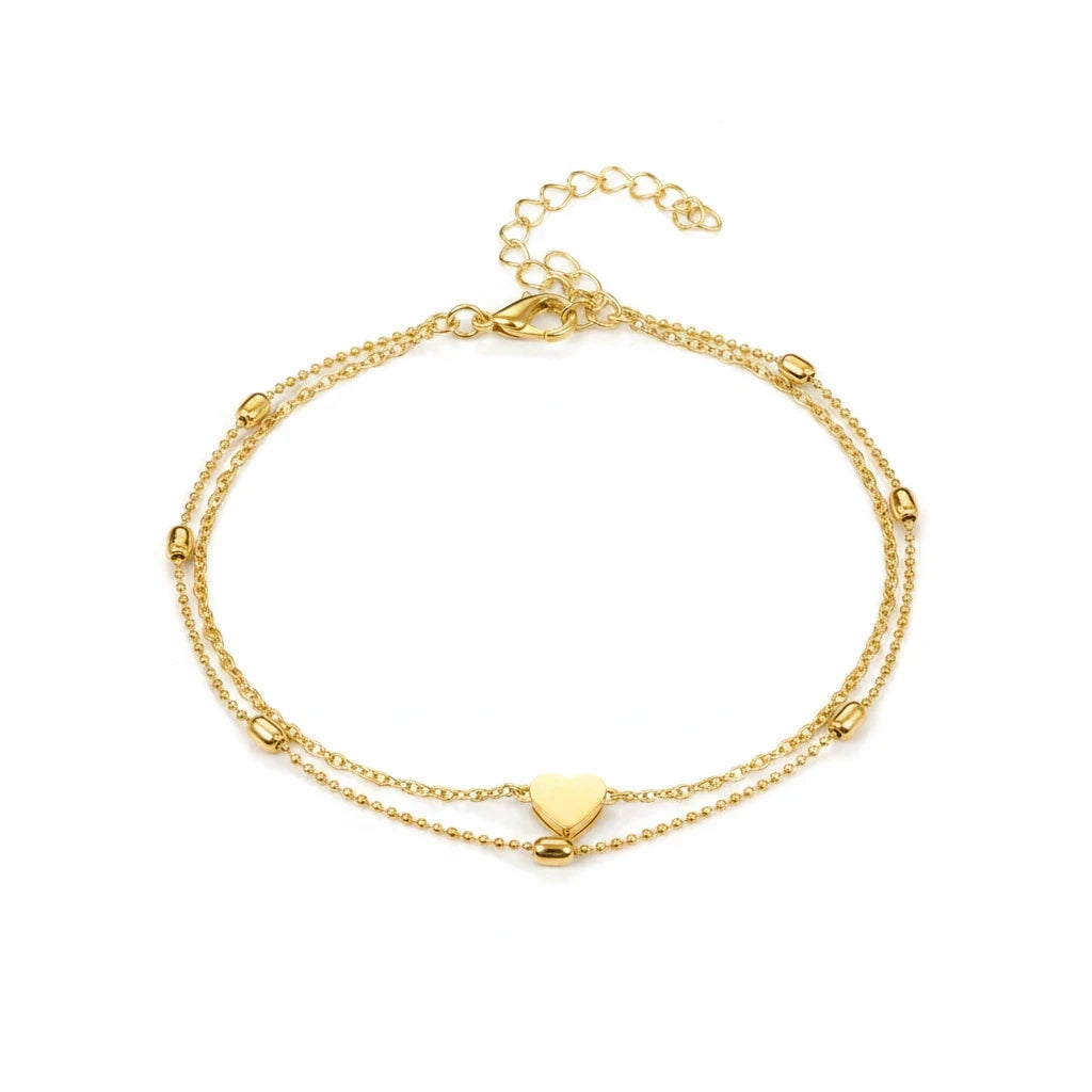 Aramat Jewels gold-colored double-layered stainless steel anklet featuring a heart charm and delicate beads.