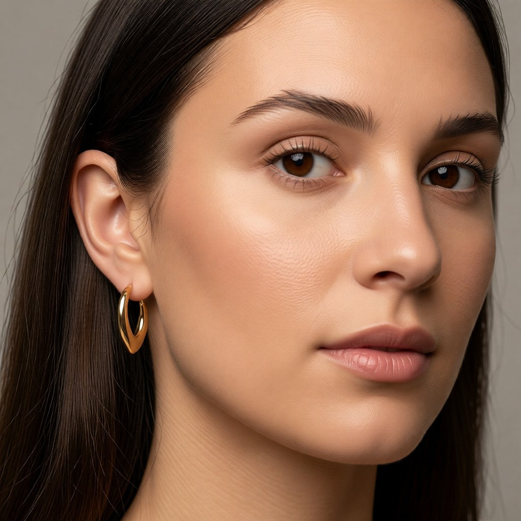 Aramat Jewels gold-tone stainless steel drop hoop earrings, 22mm, with a hinge closure.